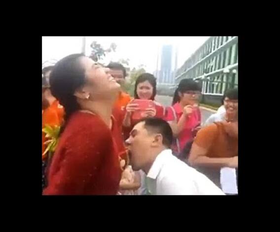 Men compete to eat grapes hung around the breasts of women