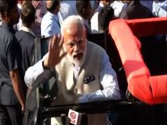 PM Narendra Modi waves, shows inked finger after casting vote