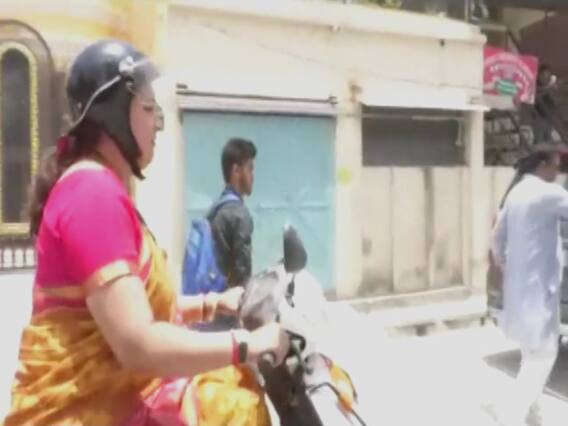 Smriti Irani rides a scooty on last day of campaigning
