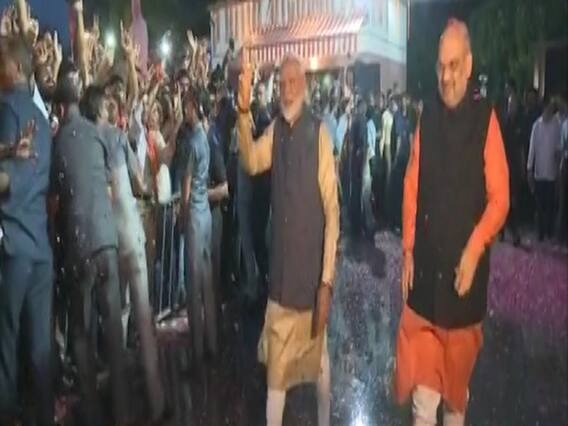 Delhi: PM Modi waves at BJP supporters in party office
