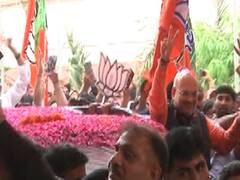 Excited workers take selfie with Amit Shah at party headquarters